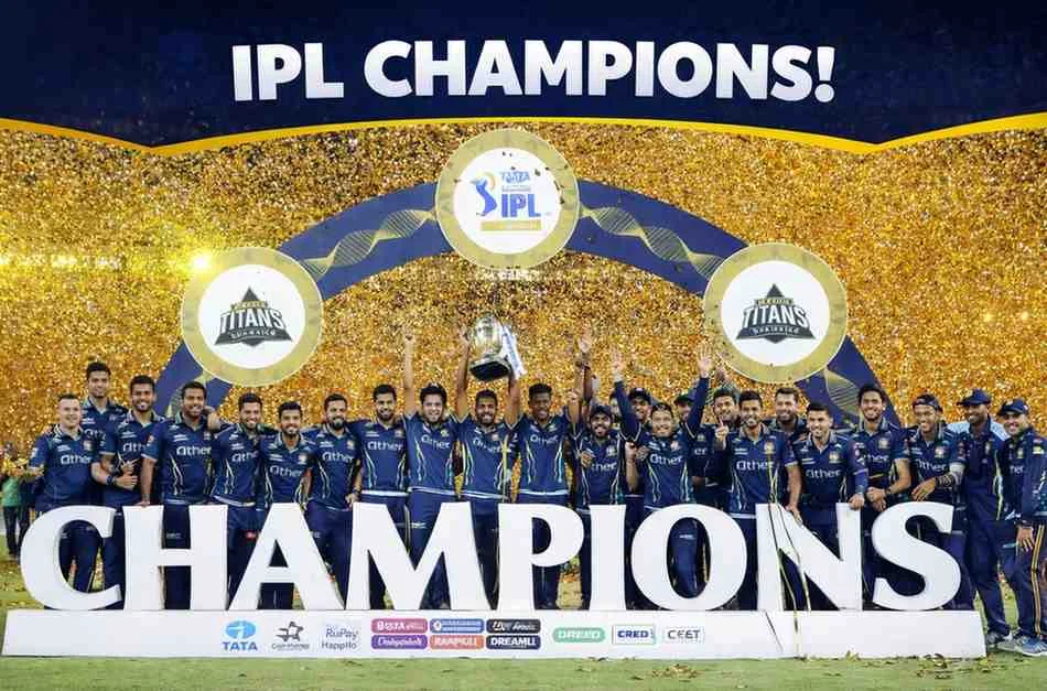 IPL 2026 Team Squads image showing Gujarat Titans celebrating championship victory with full team on stage